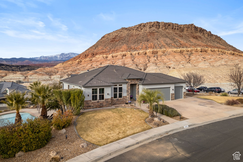 View of front of house with a garage and a mountain view
