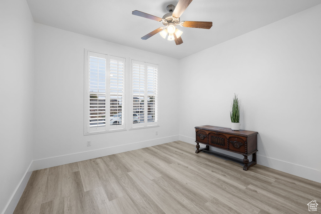 Spare room featuring ceiling fan and light wood-type flooring