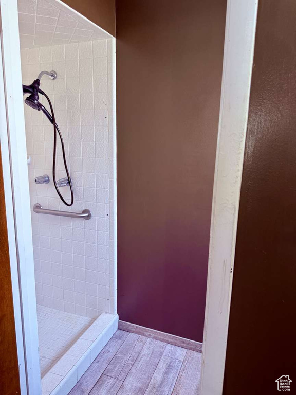Full bathroom with a stall shower and wood finished floors