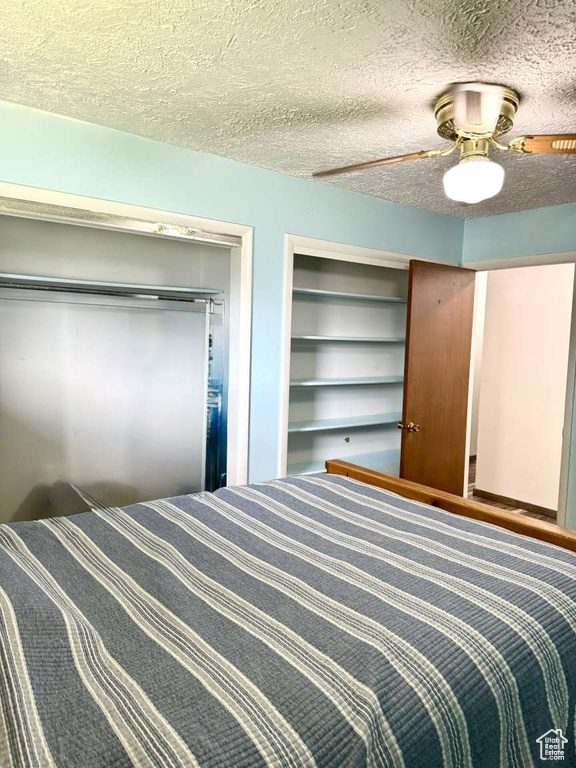 Bedroom featuring a textured ceiling and ceiling fan