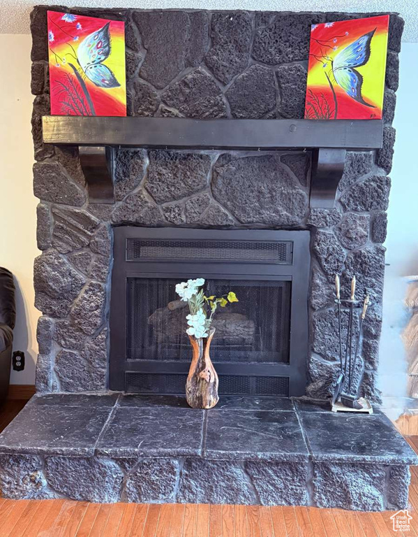 Detailed view of a fireplace and wood finished floors