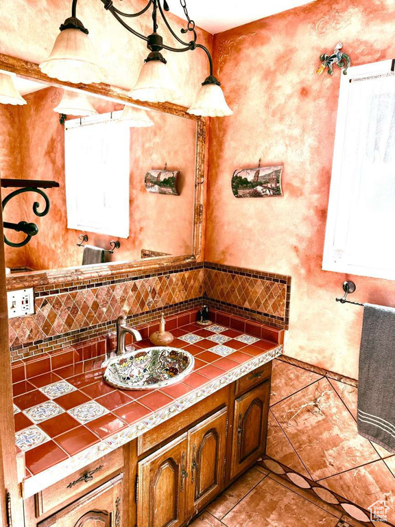 Bathroom with vanity, backsplash, and tile patterned flooring