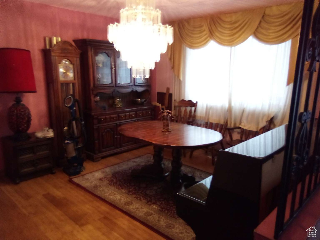 Dining area featuring light wood-type flooring and a chandelier