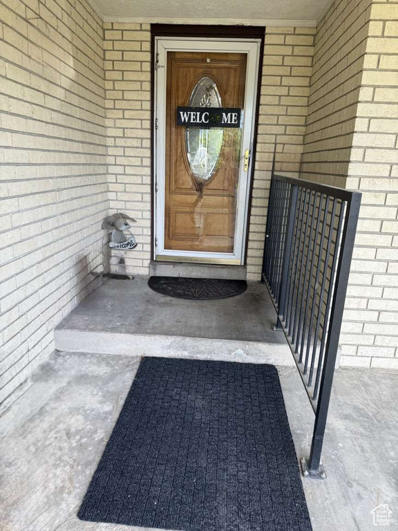 Entrance to property with brick siding
