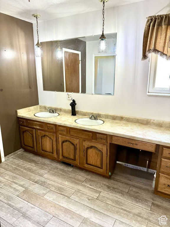 Full bathroom featuring wood finish floors and double vanity