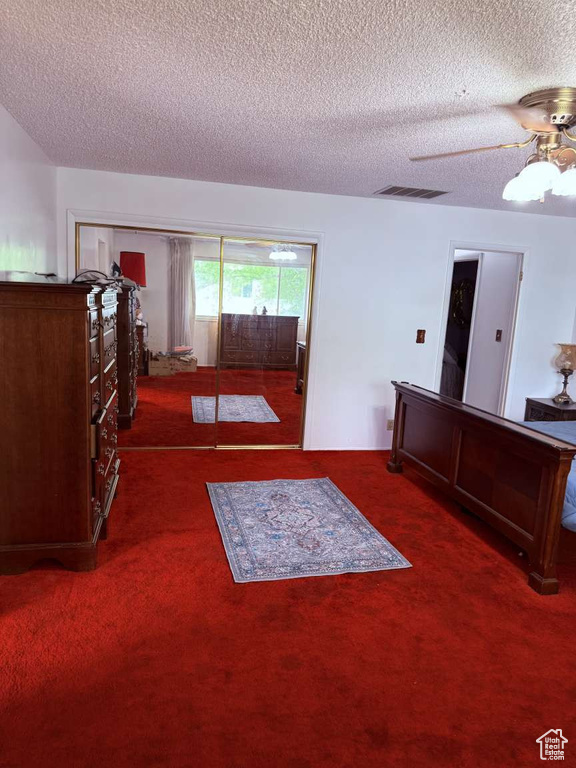 Carpeted bedroom featuring a textured ceiling, a ceiling fan, and access to exterior