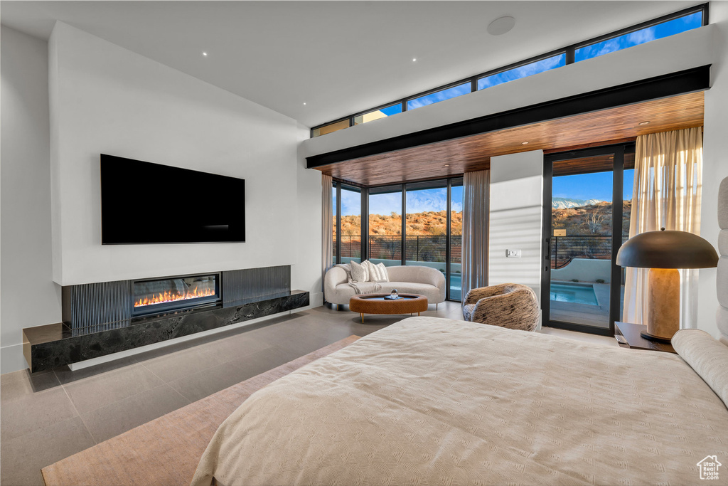 Bedroom with access to outside and a premium fireplace