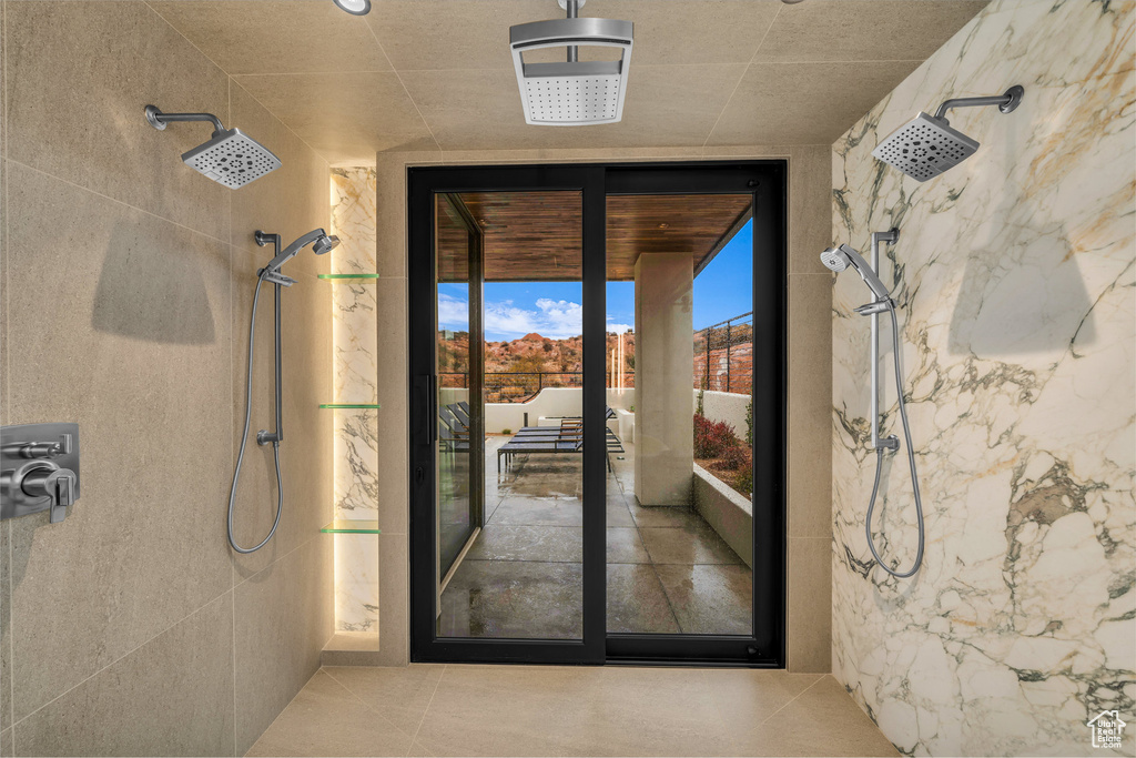 Doorway featuring expansive windows and tile patterned floors