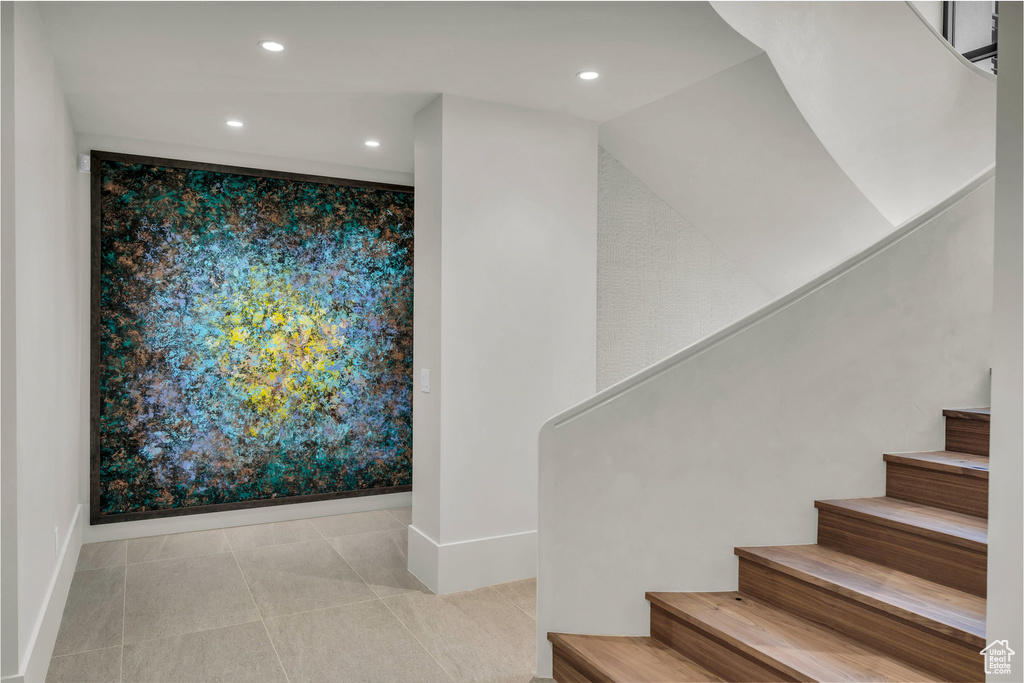 Stairs featuring recessed lighting and tile patterned floors
