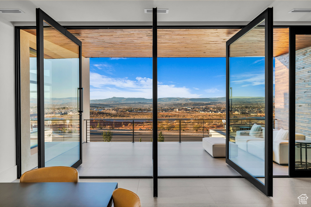 Entryway featuring a wall of windows and a mountain view