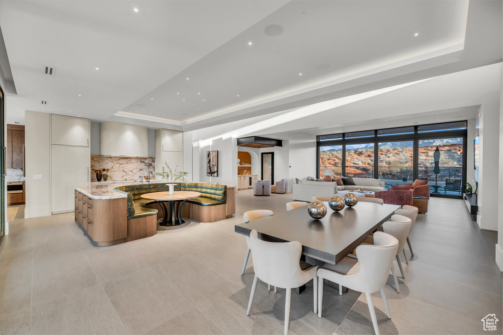 Dining space featuring a raised ceiling