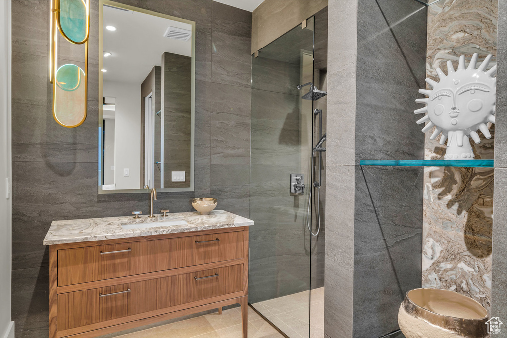 Bathroom with walk in shower, vanity, and recessed lighting