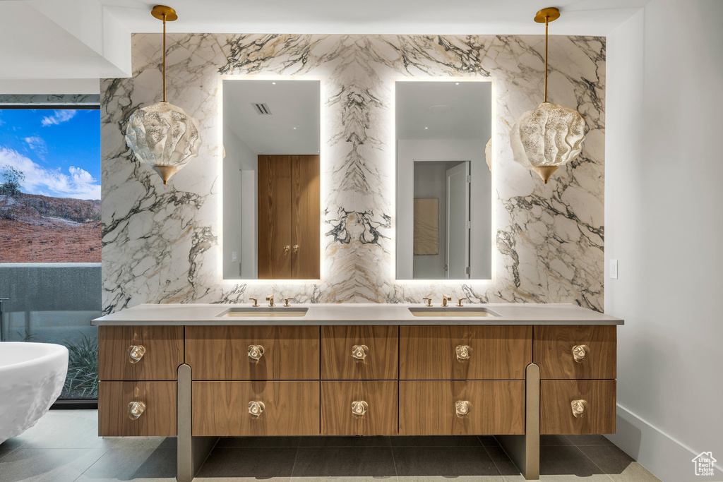 Bathroom featuring double vanity and a soaking tub