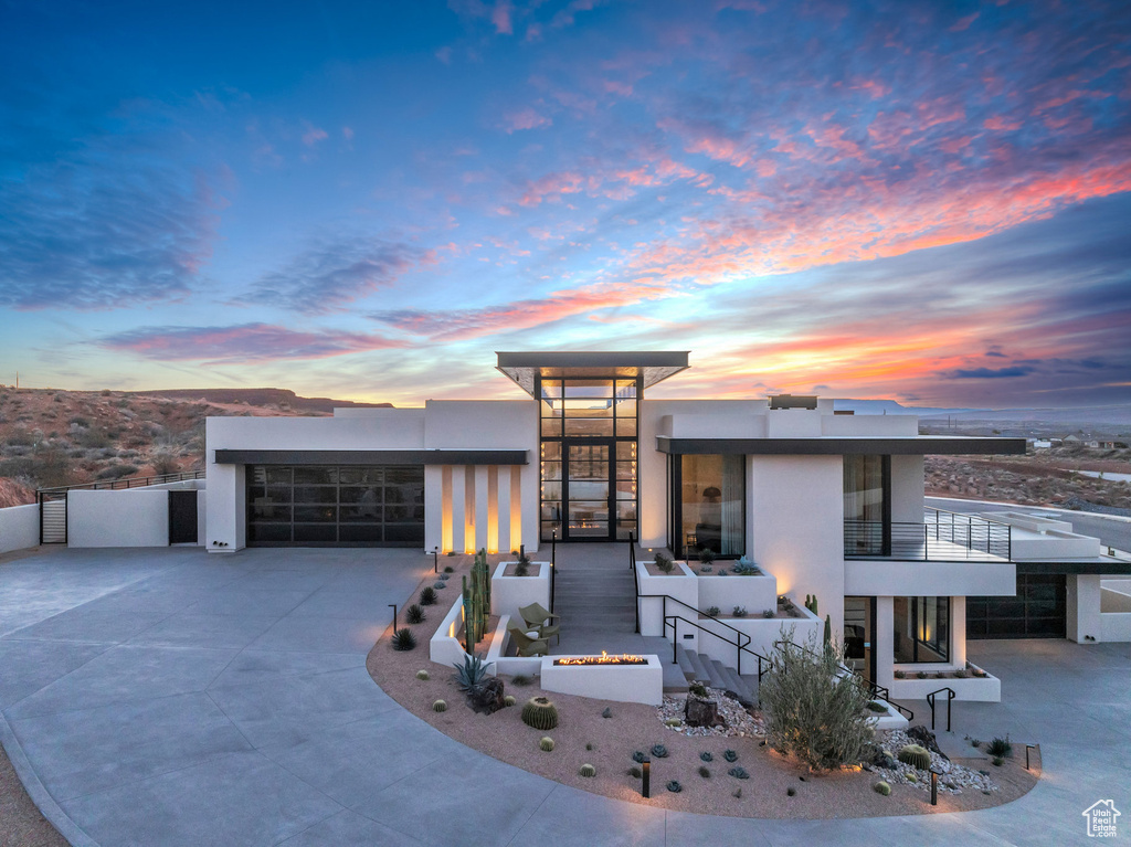 Modern home featuring stucco siding, concrete driveway, and a garage