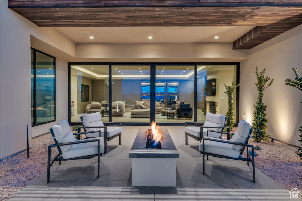View of patio with an outdoor living space with a fire pit