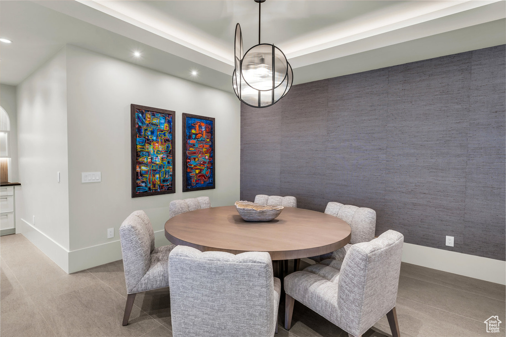 Dining area with recessed lighting and light carpet