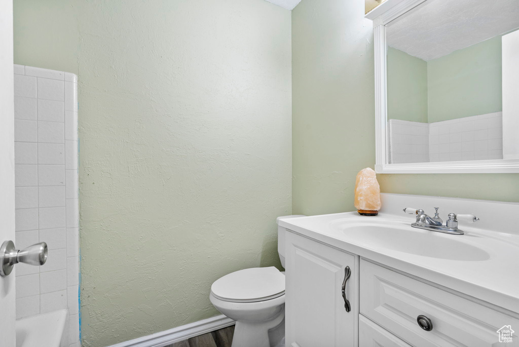 Full bathroom with shower / tub combination, vanity, and toilet