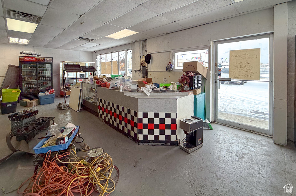 Miscellaneous room featuring a drop ceiling and concrete floors