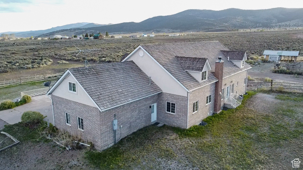 Aerial view of property and surrounding area with a mountainous background