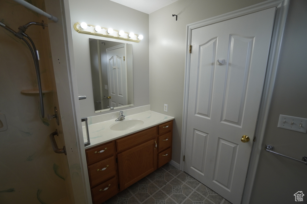 Bathroom featuring walk in shower and vanity