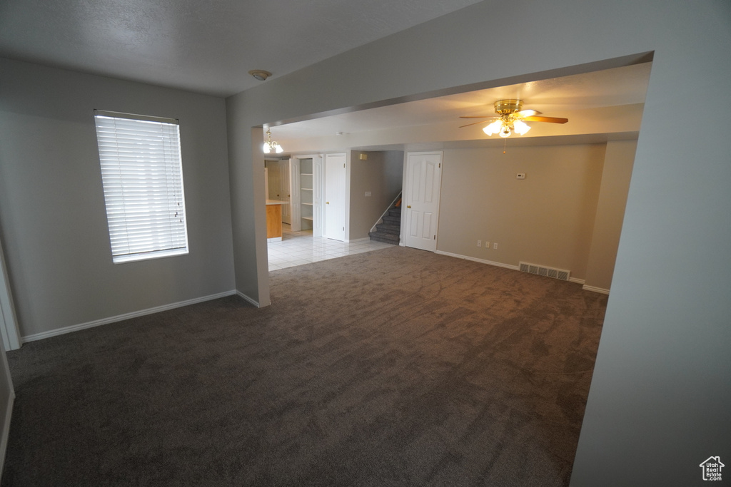 Carpeted empty room with ceiling fan