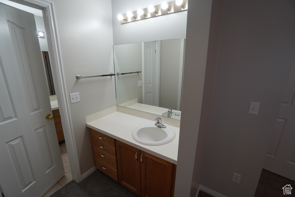 Bathroom with vanity and tile patterned flooring