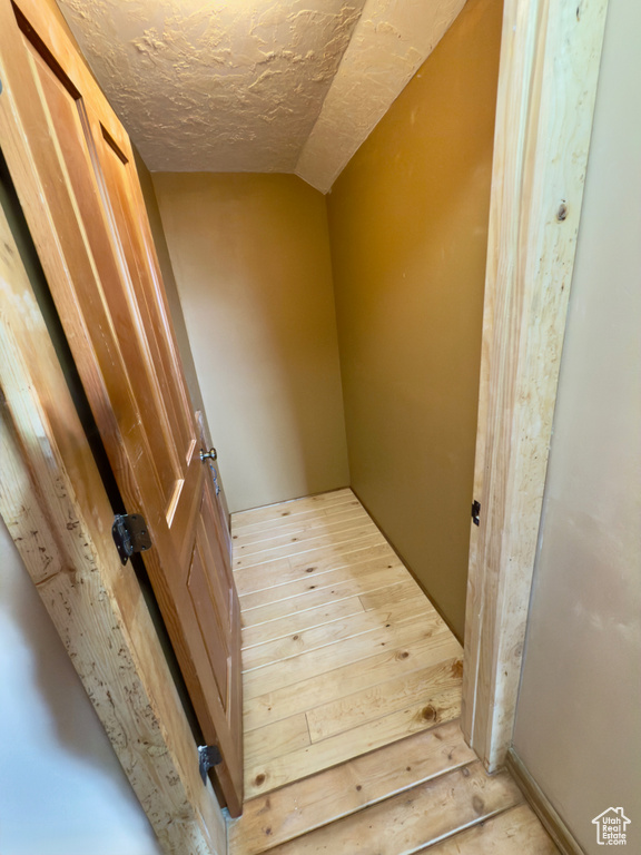 Stairway featuring lofted ceiling