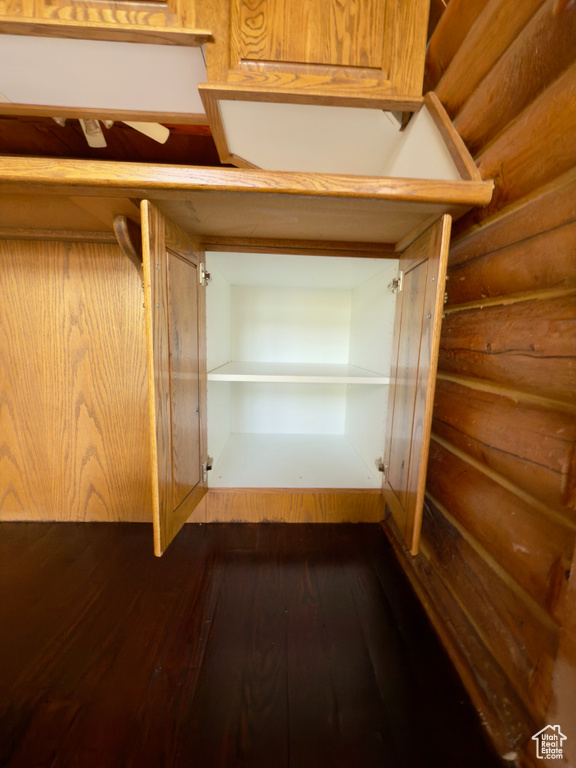 Spacious closet featuring dark wood finished floors