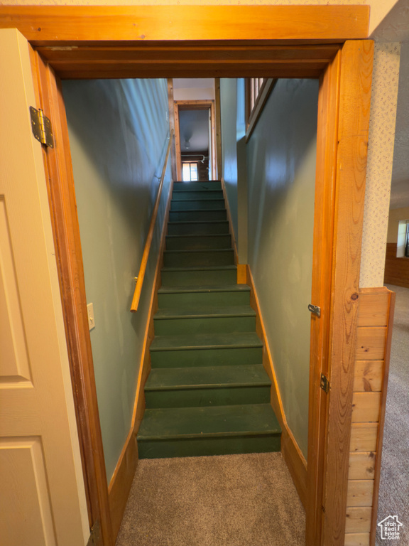 Stairway featuring carpet and baseboards