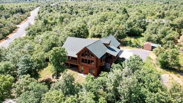 View of subject property with a forest