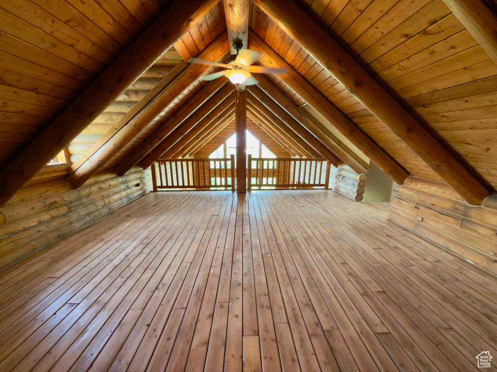 Additional living space with wood ceiling, wood-type flooring, and ceiling fan