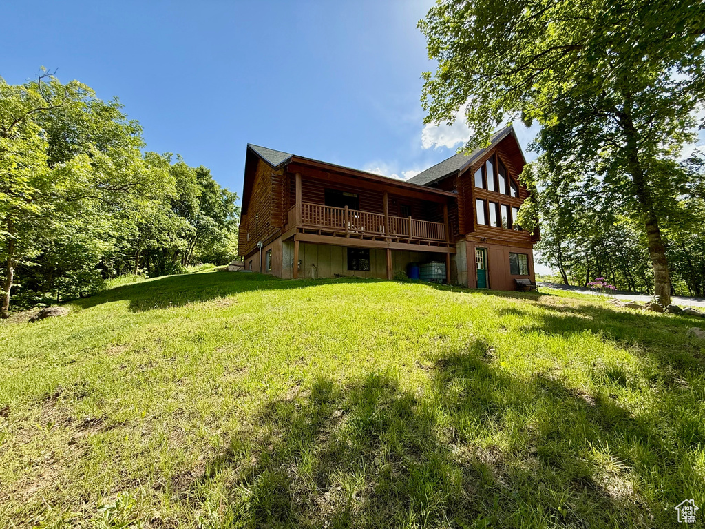 Back of property with a lawn and a deck
