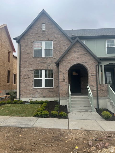 View of front of house featuring brick siding