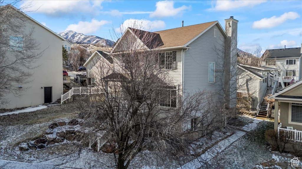 View of snow covered exterior featuring a mountain view