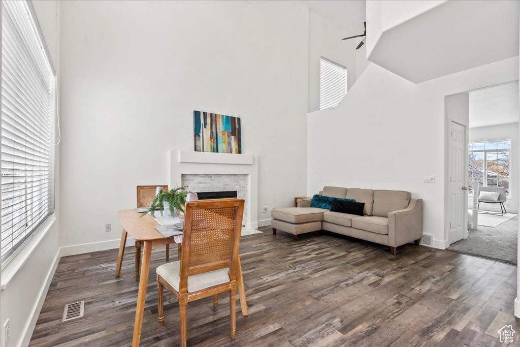 Dining room with a high ceiling and dark wood-type flooring