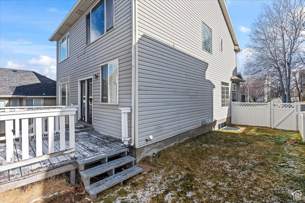 View of home's exterior with a wooden deck