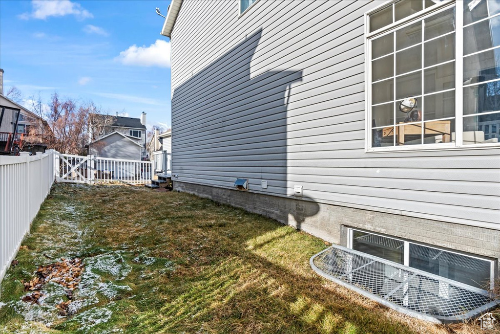 View of property exterior featuring a lawn