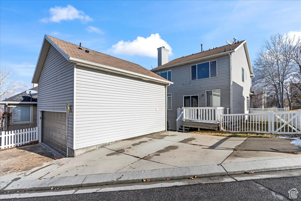 Rear view of property featuring a garage