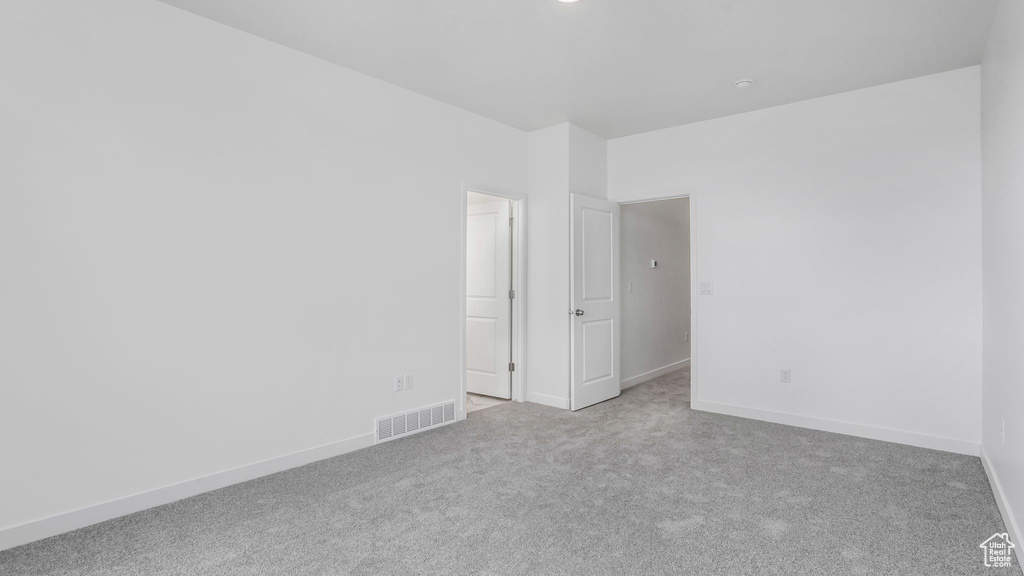 Empty room featuring carpet floors and baseboards