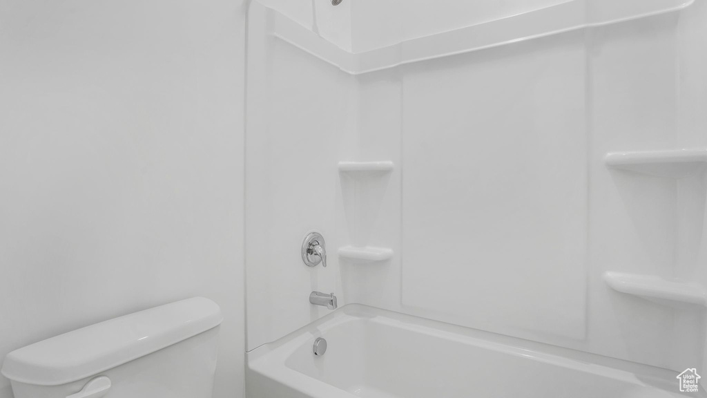 Full bathroom with toilet and bathing tub / shower combination