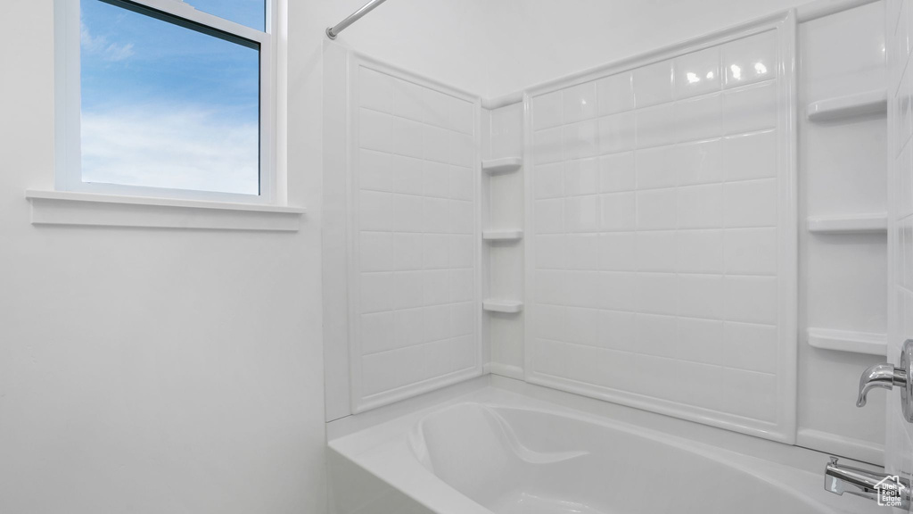 Full bath featuring washtub / shower combination and plenty of natural light
