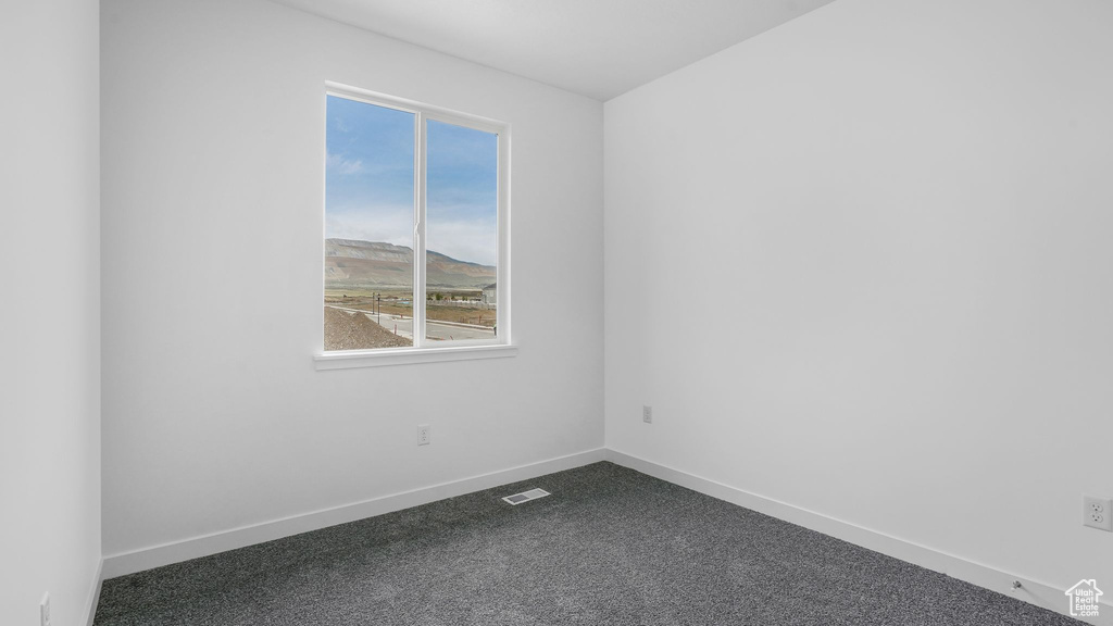 Empty room featuring healthy amount of natural light and baseboards