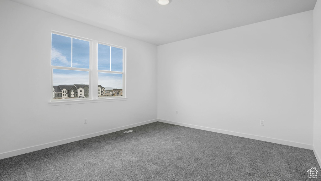 Empty room with carpet flooring and baseboards