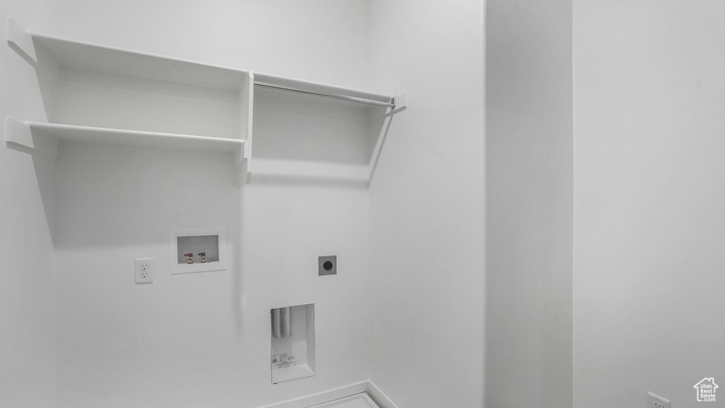 Laundry area with electric dryer hookup, washer hookup, and baseboards