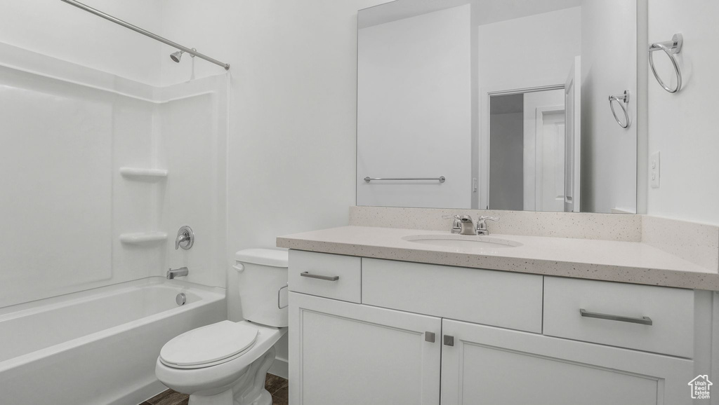 Bathroom with toilet, vanity, and shower / bath combination