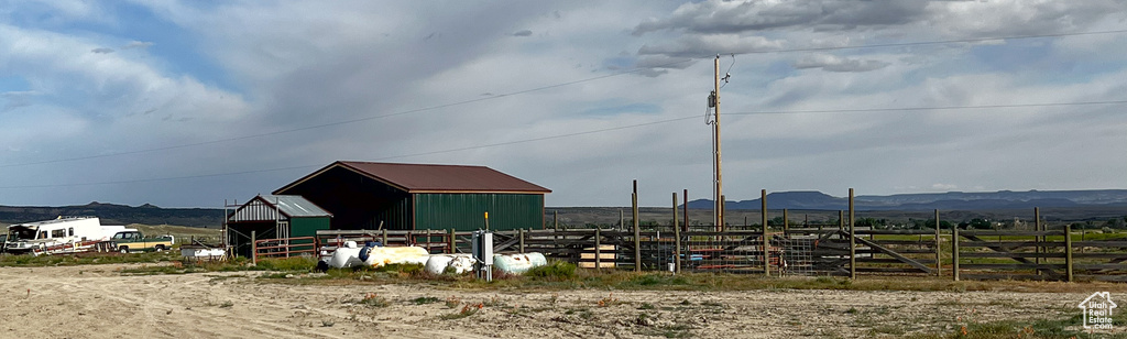 View of outdoor structure with a mountain view and a rural view