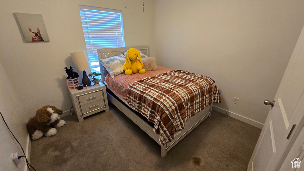 Bedroom featuring dark colored carpet