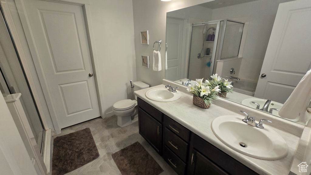 Bathroom featuring vanity and a shower with door