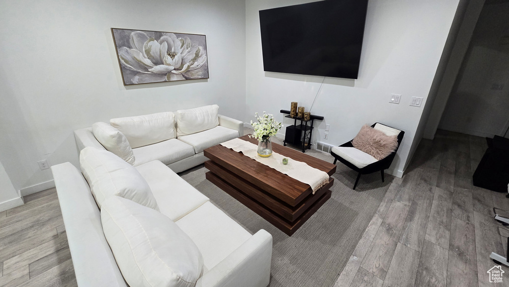 Living room with light hardwood / wood-style flooring