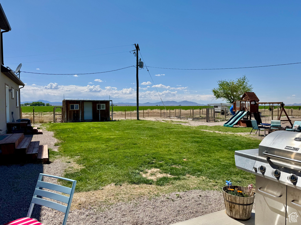 View of yard featuring a mountain view and a playground